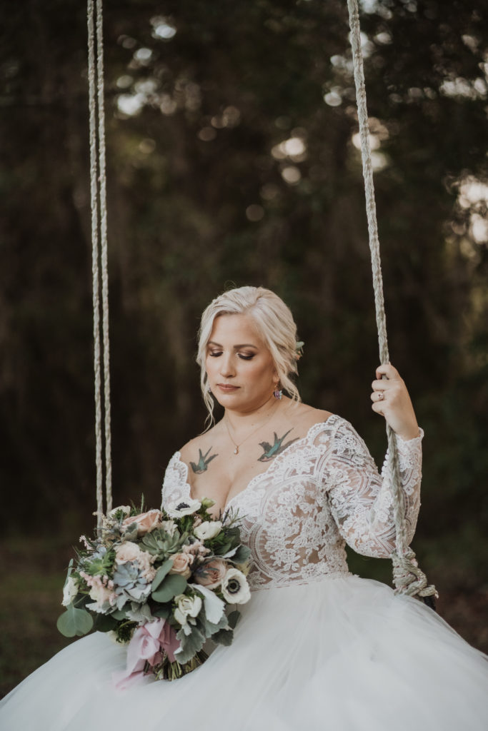 bride on swing at chandler oaks barn